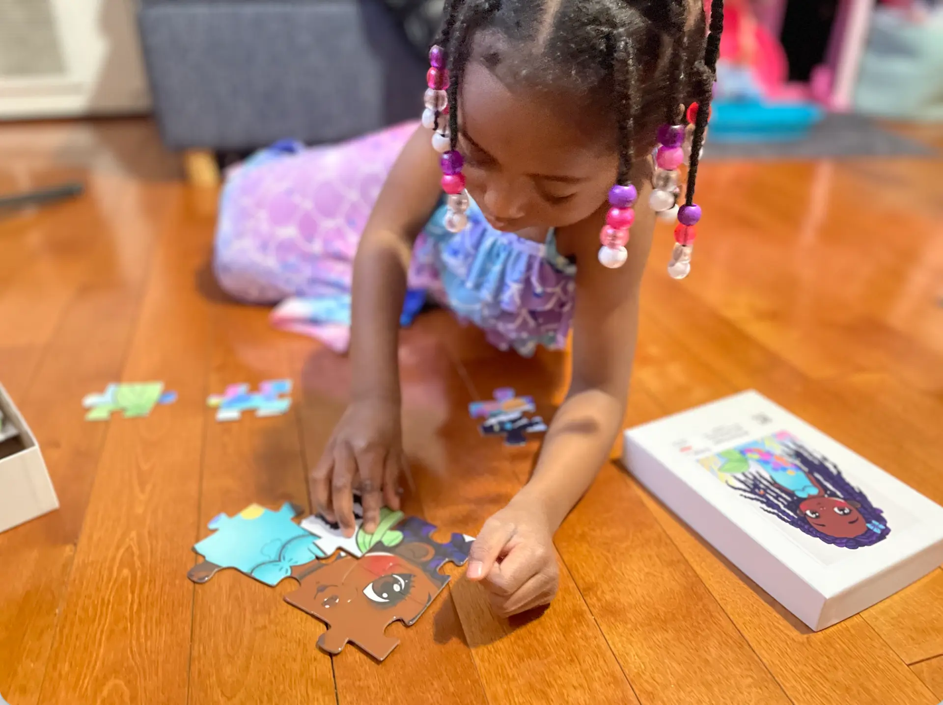 Young Augustine in a mermaid outfit putting together the first pieces of the original mermaid puzzle